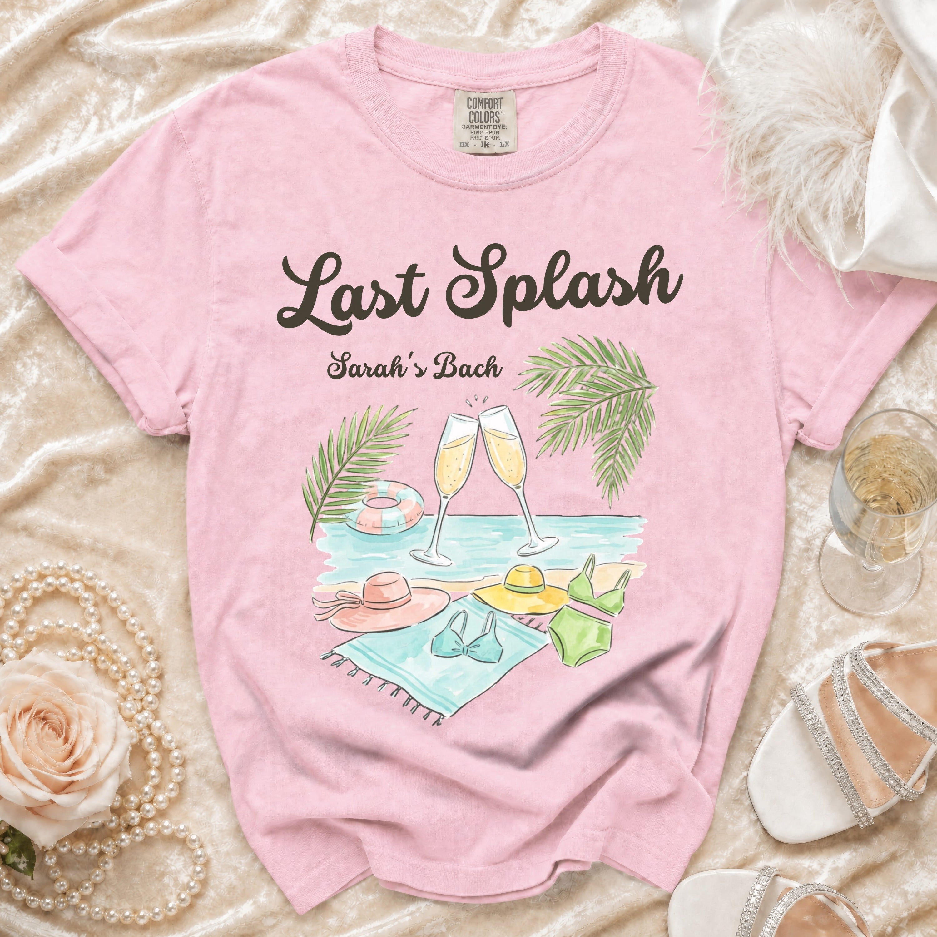 Pink t-shirt with "Last Splash Sarah's Bach" and beach graphic.