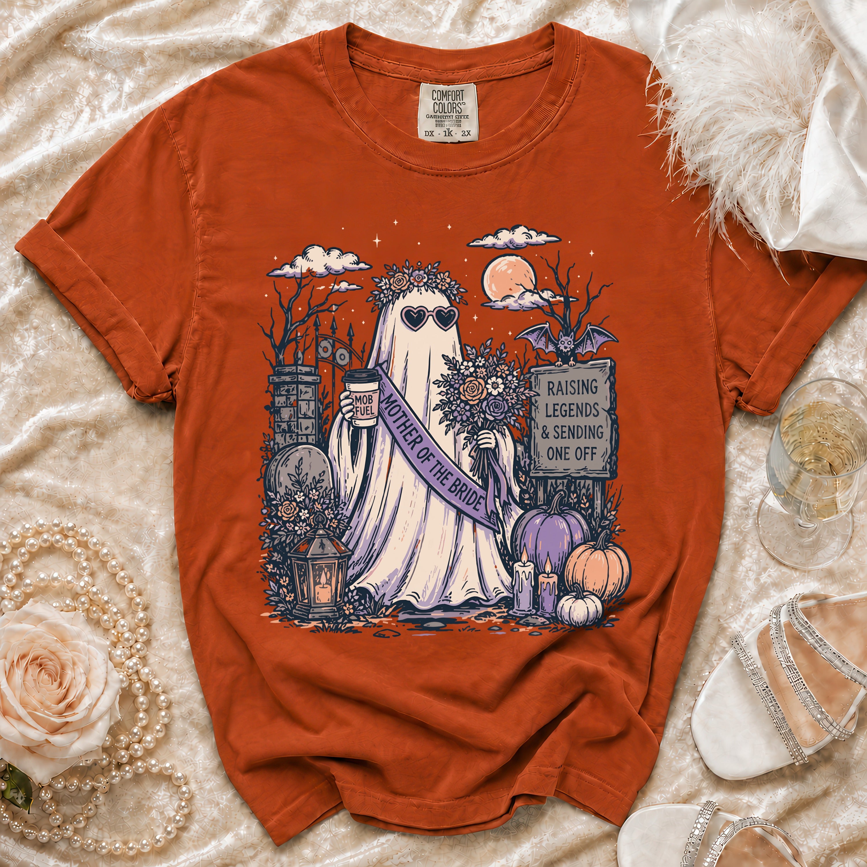 Orange t-shirt with ghost graphic wearing heart sunglasses and "Mother of the Bride" sash.