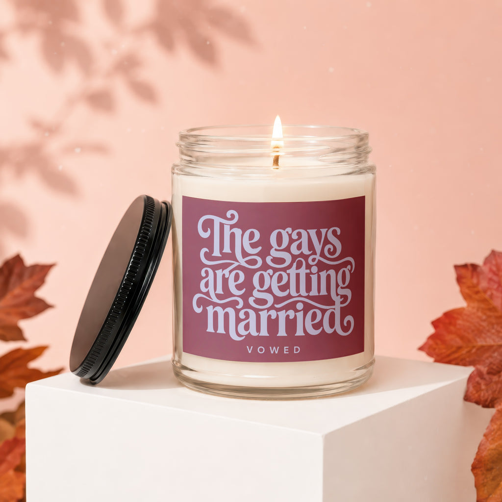 Candle with text "The gays are getting married vowed" on a marble pedestal.