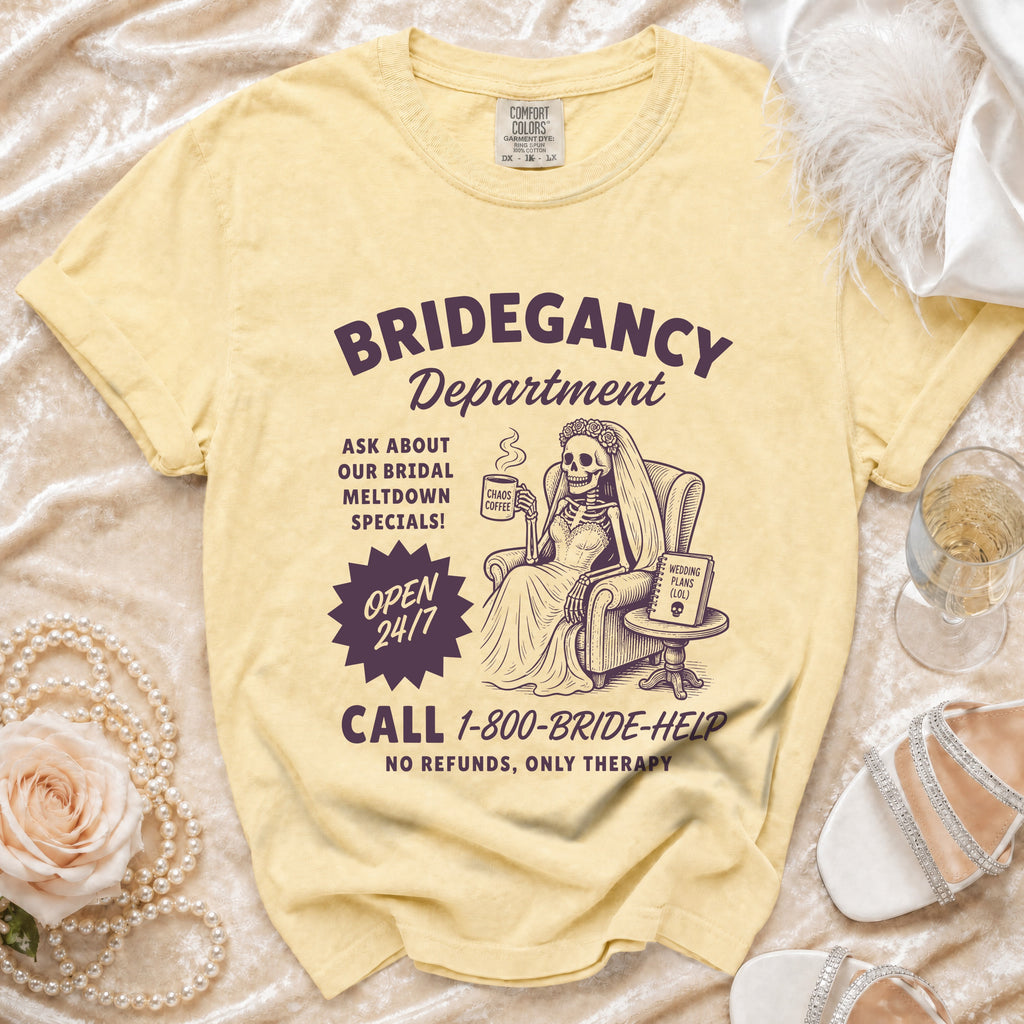 Yellow t-shirt with "Bridegancy Department" graphic of a skeleton bride with "Chaos Coffee."