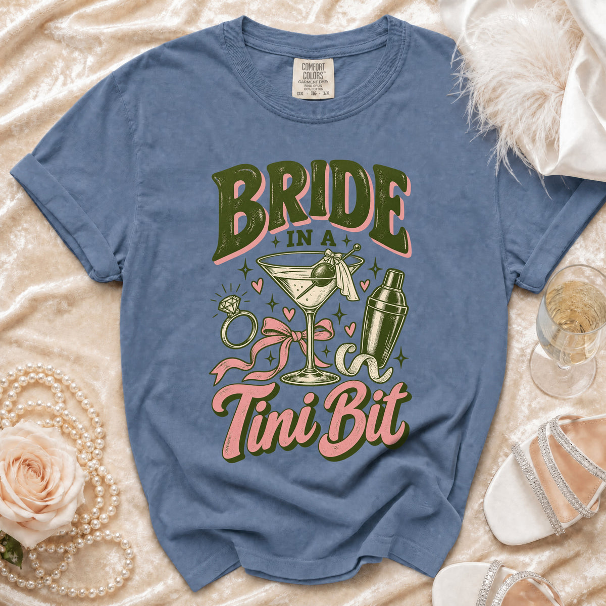 Blue t-shirt with "Bride in a Tini Bit" graphic, martini, and cocktail shaker.