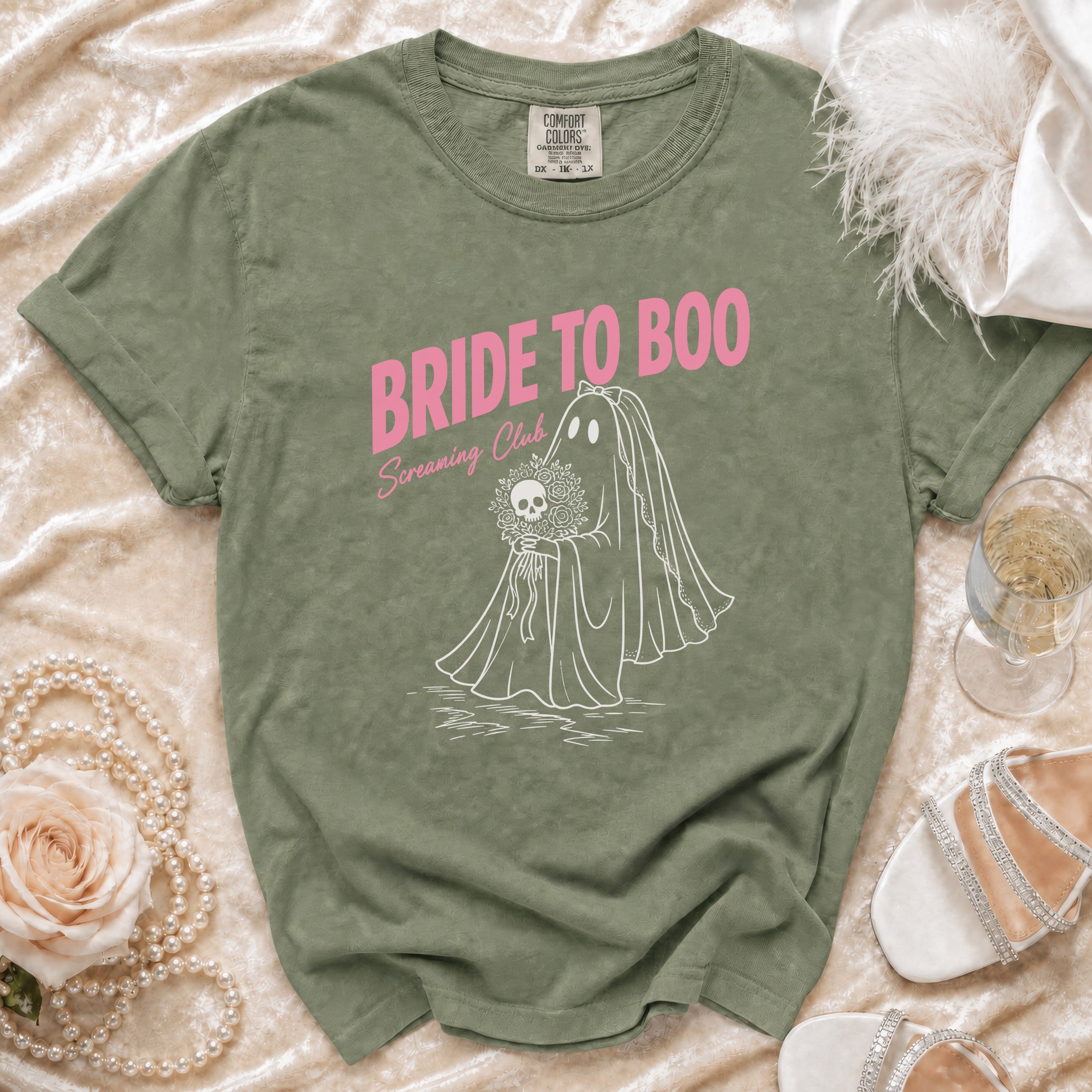 Green t-shirt with pink text "Bride to Boo Screaming Club" and ghost bride graphic.