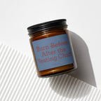 Candle with black lid and blue label reading "Burn Before After the Seating Chart."