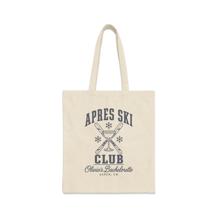 A natural canvas tote bag with a black printed graphic featuring crossed skis, a champagne glass, and the text Apres Ski Club Olivia's Bachelorette Aspen, CO.