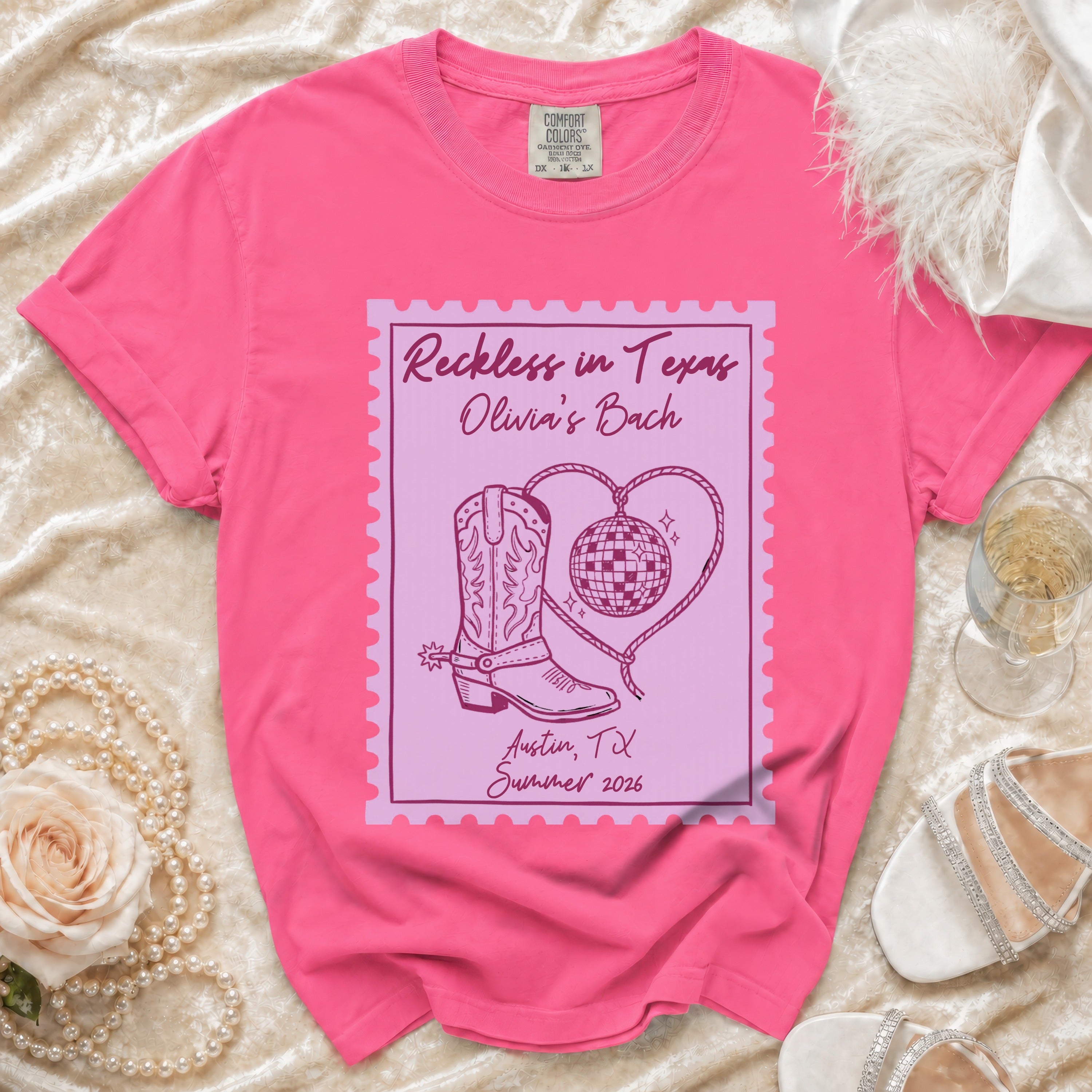 Pink t-shirt with "Reckless in Texas Olivia's Bach" and boot design.