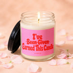 Lit candle in a jar with pink label that reads "I've Earned This Candle".