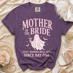 Purple t-shirt with "Mother of the Bride Raising Hell Since Day One" text and ghost graphic.