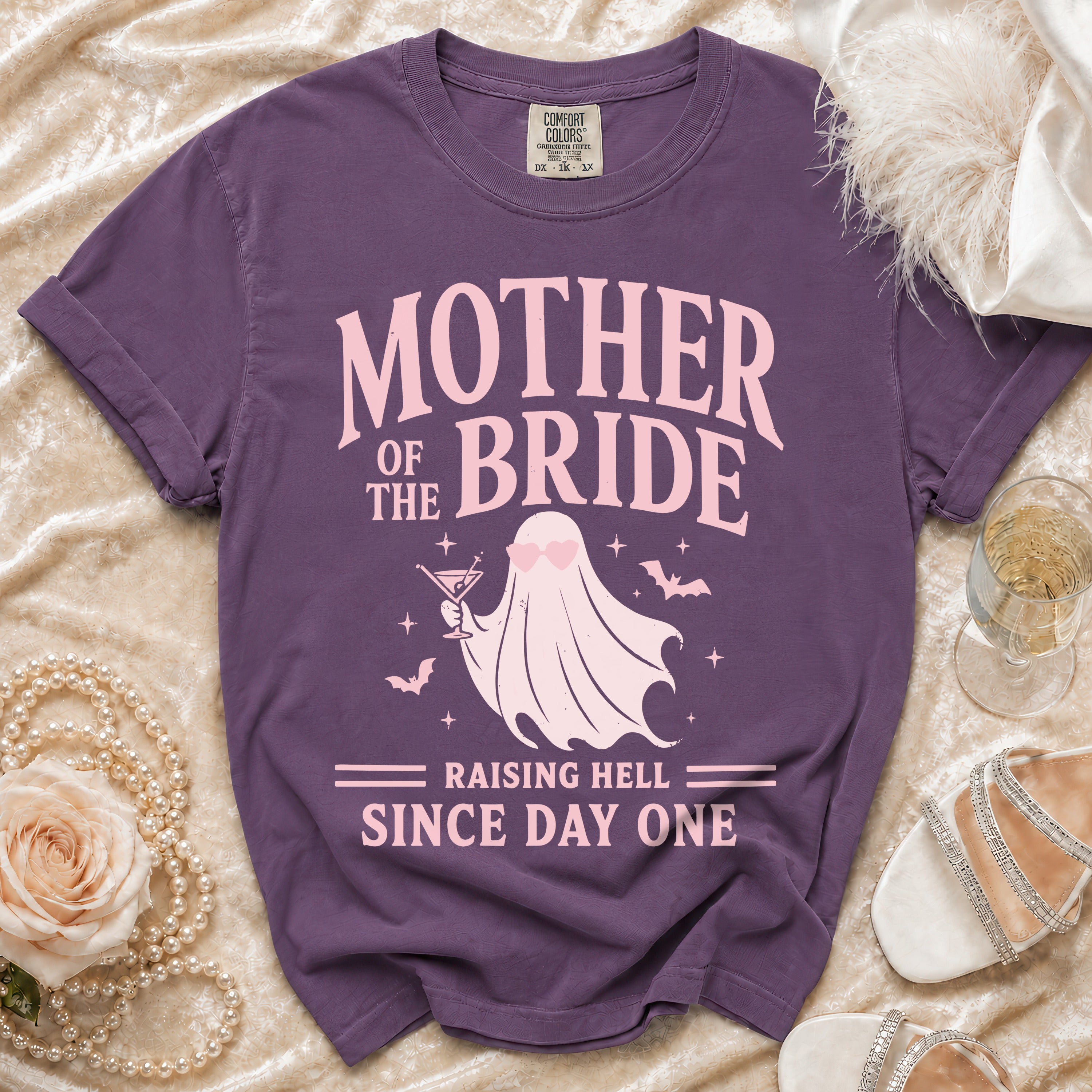 Purple t-shirt with "Mother of the Bride Raising Hell Since Day One" text and ghost graphic.