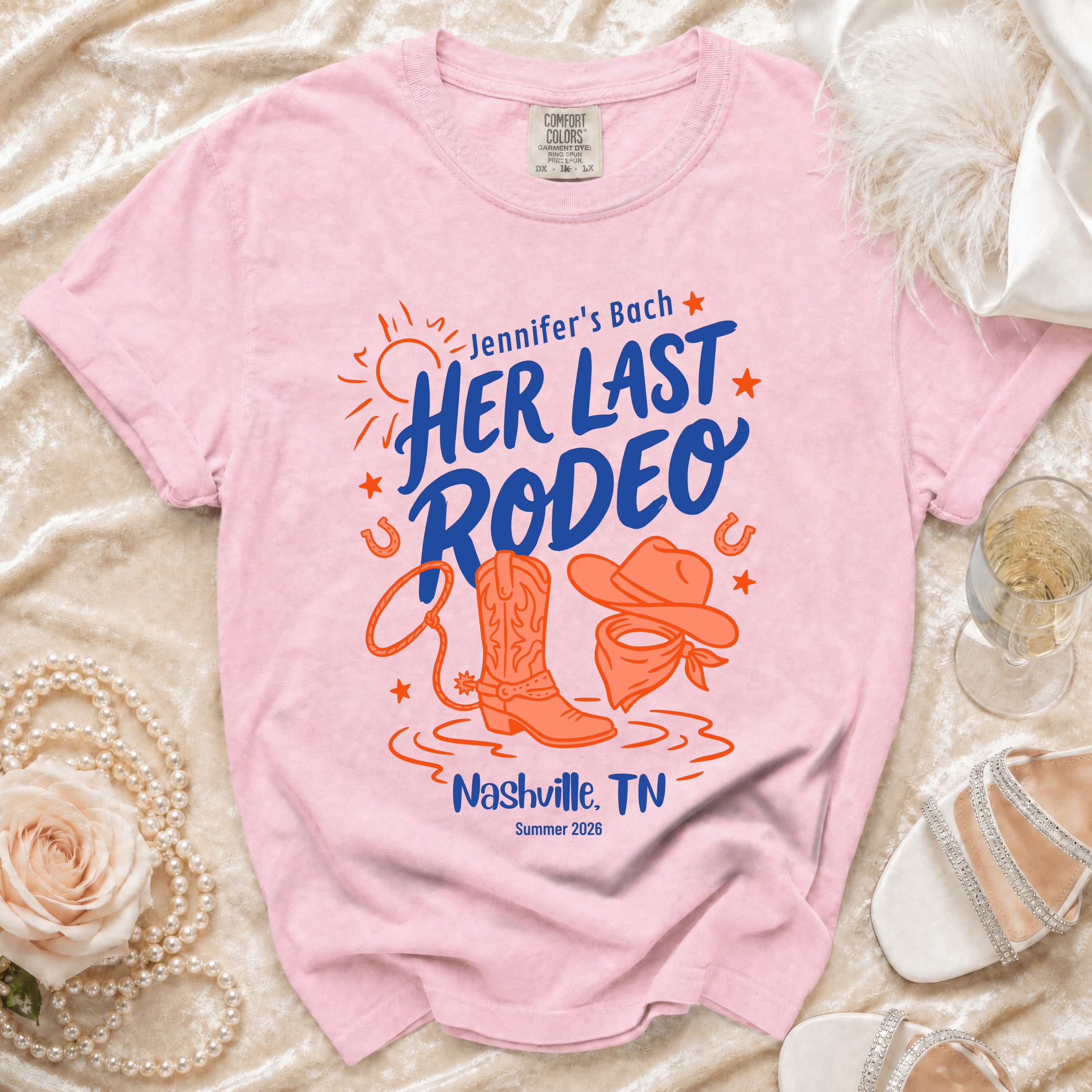 Pink t-shirt with "Jennifer's Last Rodeo" text, cowboy boot, and bandana.