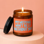 Candle with lit wick and orange label reading "MY WEDDING WON'T BE LIT WITHOUT YOU".