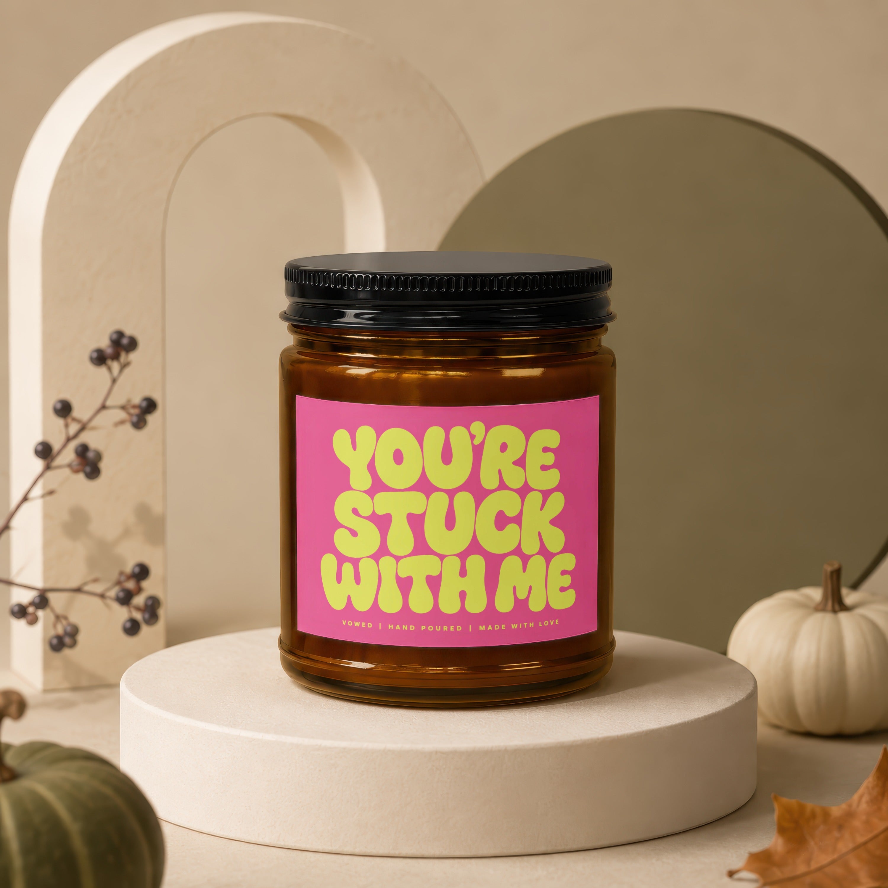 Amber jar candle with a pink label that says "YOU'RE STUCK WITH ME"
