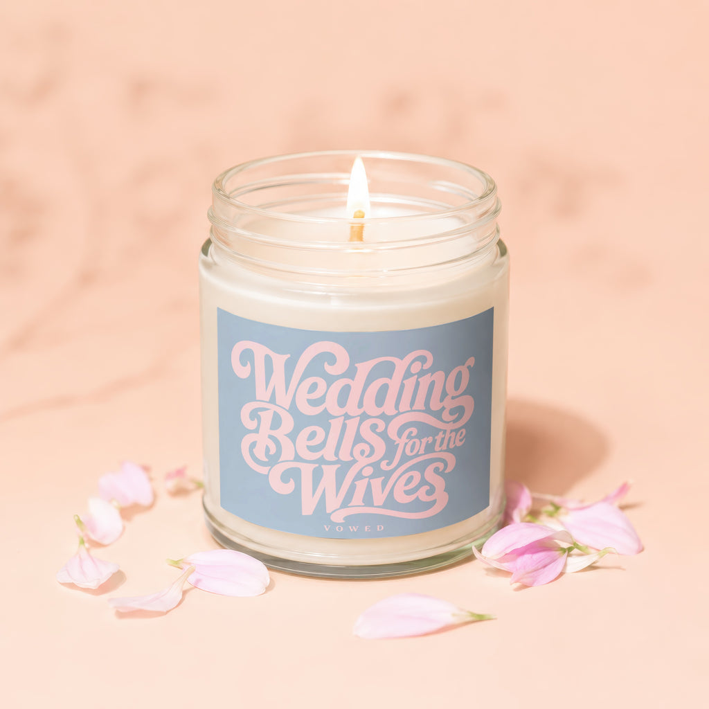 Jar candle with "Wedding Bells for the Wives" text and pink petals.