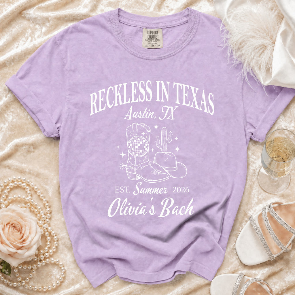 Lavender comfort colors t-shirt with "Reckless in Texas Austin, TX Est. Summer 2026 Olivia's Bach" and graphics.