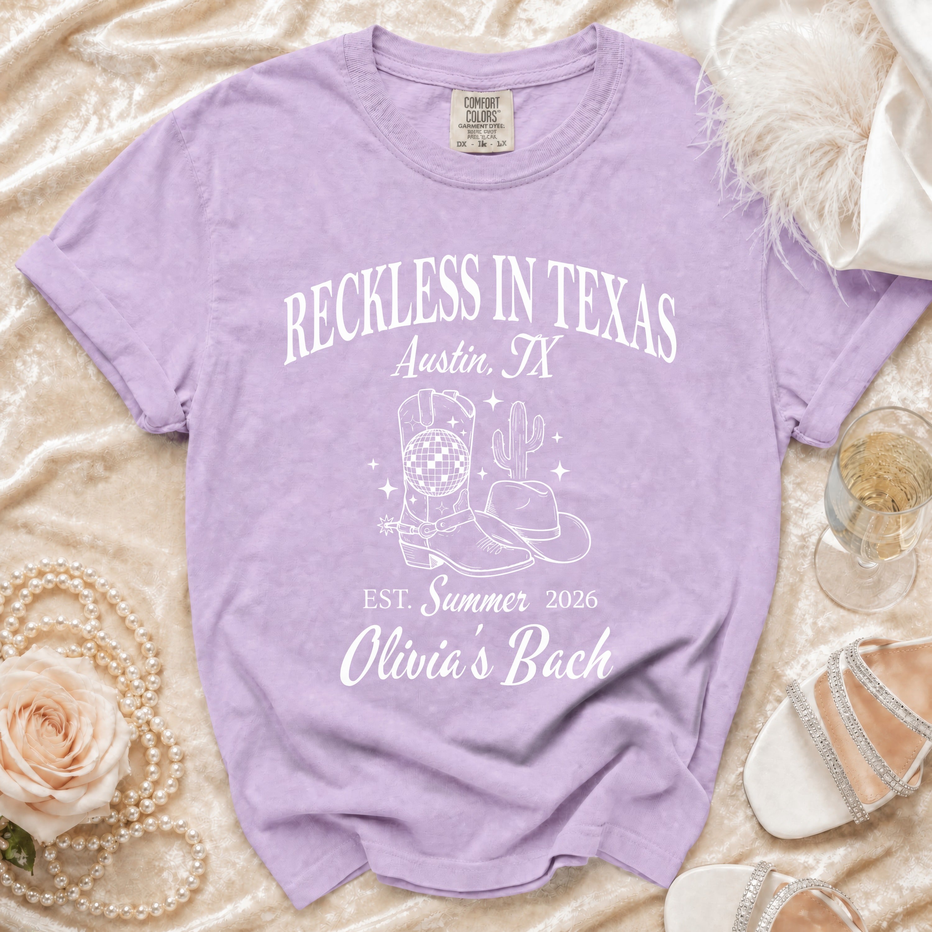 Lavender comfort colors t-shirt with "Reckless in Texas Austin, TX Est. Summer 2026 Olivia's Bach" and graphics.