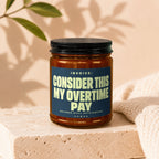 Jar with black lid, textured label reading "INVOICE: CONSIDER THIS MY OVERTIME PAY BALANCE STILL OUTSTANDING VOWED".