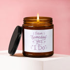 Amber glass candle with lit flame and "From Someday to Yes to I Do VOWED" text.