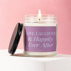 Candle with lit wick on a white stand, with text "Love, Laughter & Happily Ever After".