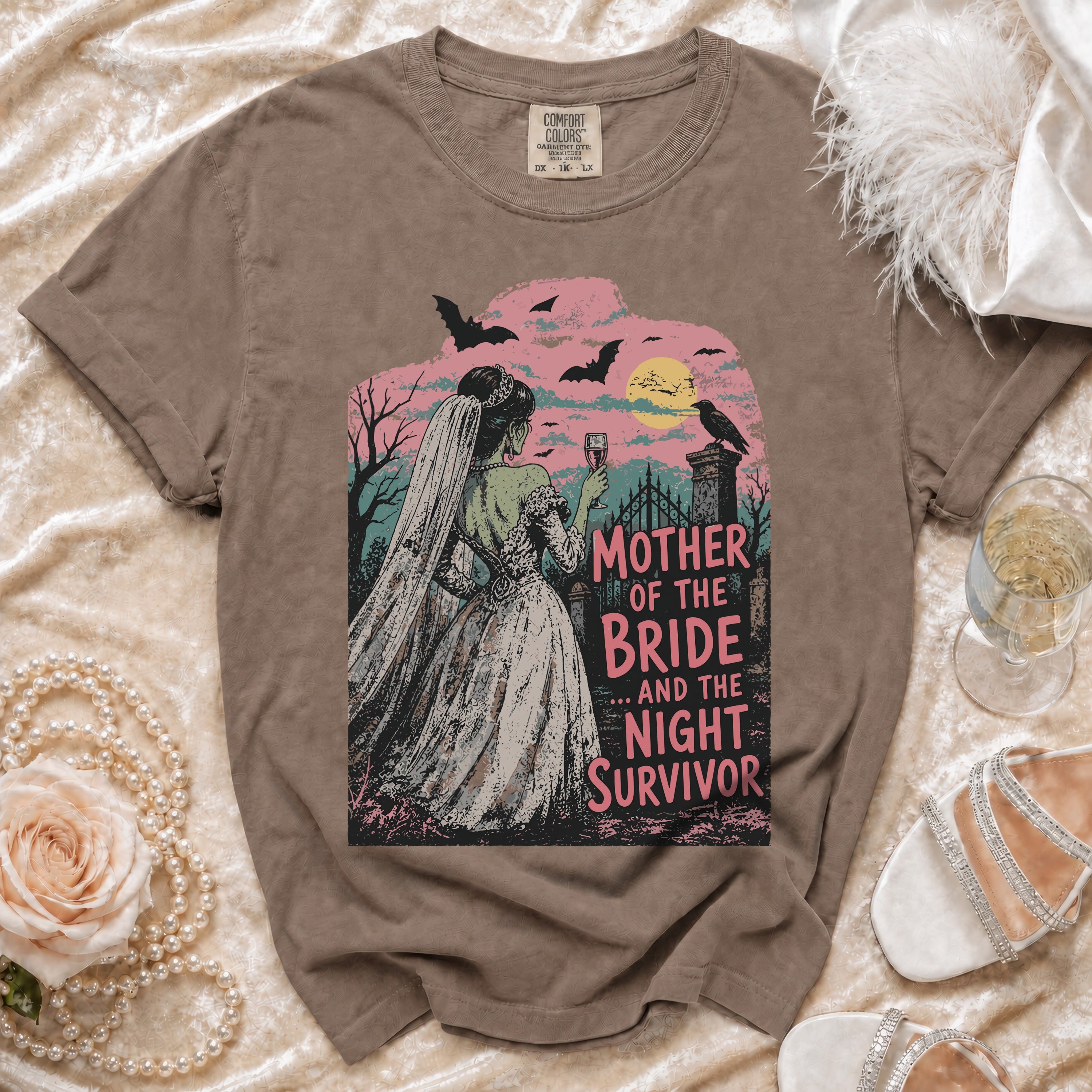 T-shirt graphic with zombie bride holding wine, text "Mother of the Bride... And the Night Survivor".