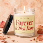 Glass jar candle with lit wick, text "Smells Like Forever & Then Some VOWED".