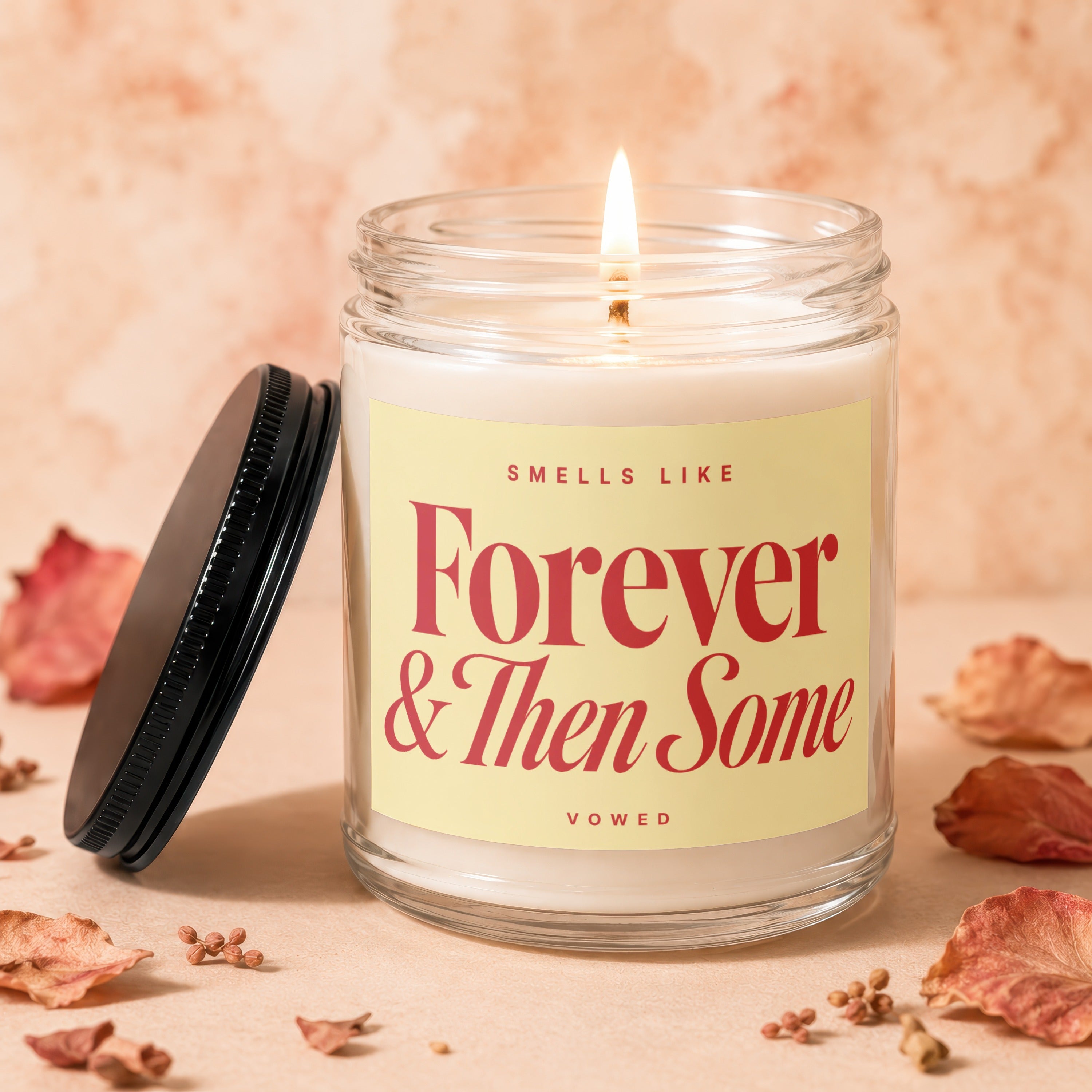 Glass jar candle with lit wick, text "Smells Like Forever & Then Some VOWED".