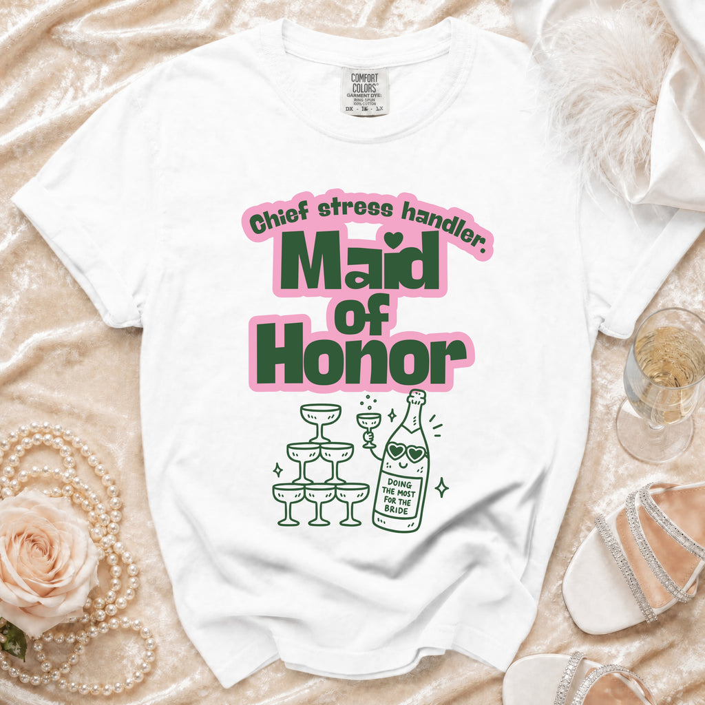 White t-shirt with "Maid of Honor" and "Chief stress handler" text and champagne illustration.