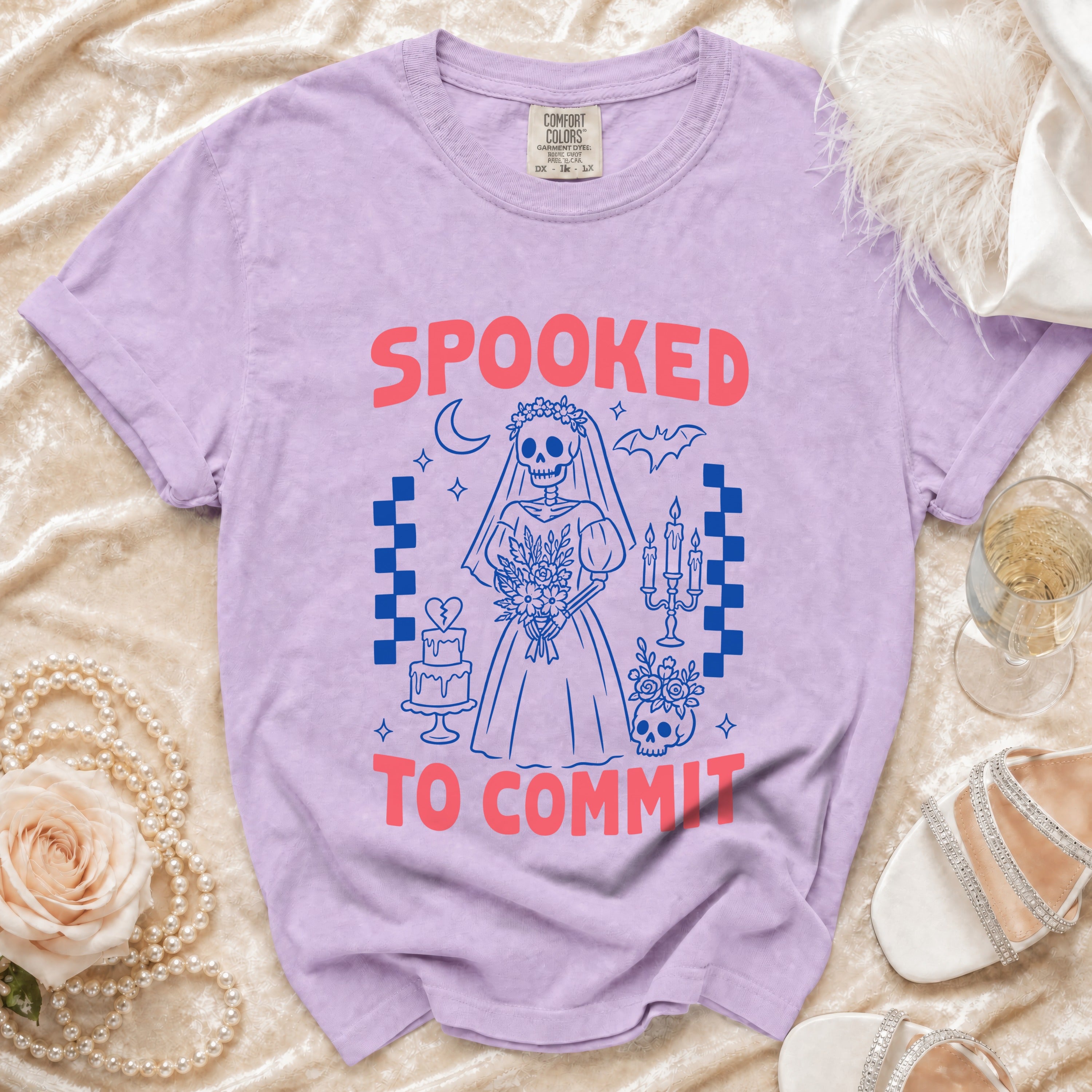 Purple t-shirt with spooky bride skeleton graphic and text "SPOOKED TO COMMIT".