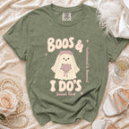Green t-shirt with ghost bride graphic saying "Boos & I Do's Social Club" and "Caffeinated & Haunted".