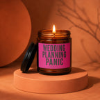 Amber jar candle with "Wedding Planning Panic Loading" text and lit wick.