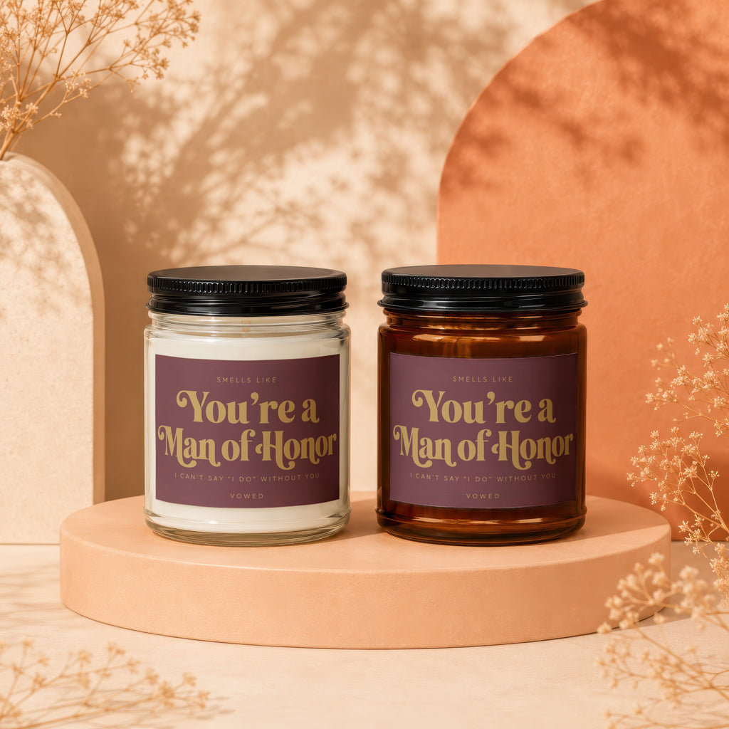 Two candles with "You're a Man of Honor" text, one clear glass, one amber.