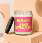 Glass candle with pink label that reads "Emotionally Legally His Problem Now".