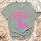 Pink cowboy boots, hat, and lasso on a vintage-style t-shirt with "Her Last Rodeo" text.