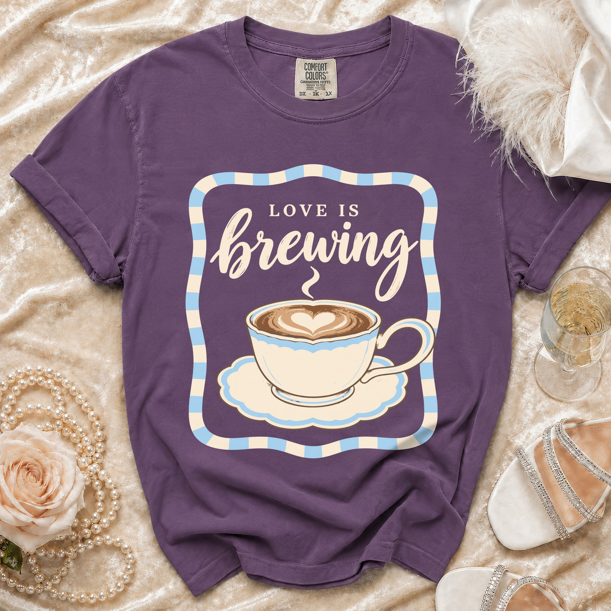Purple t-shirt with "Love is brewing" and a coffee cup graphic.