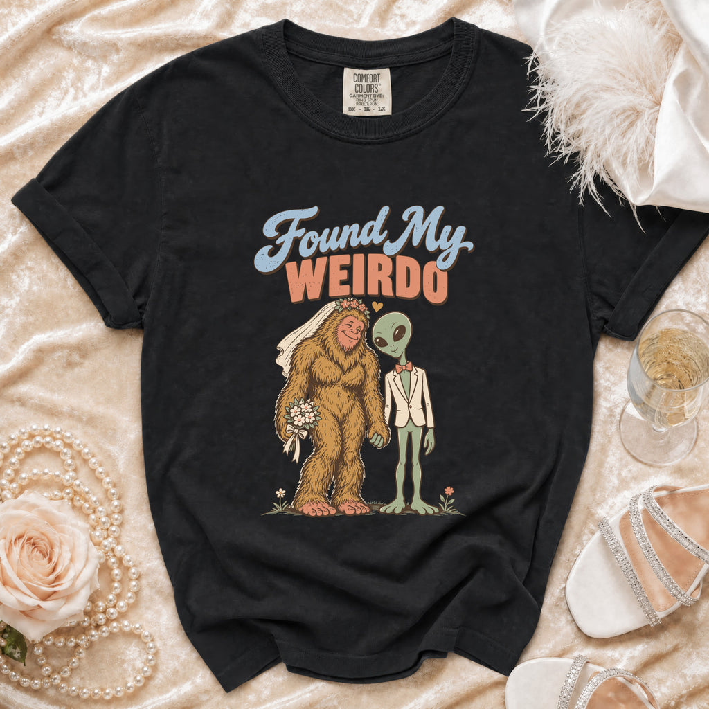 Black t-shirt with graphic of Bigfoot and alien titled "Found My WEIRDO."
