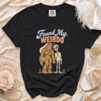 Black t-shirt with graphic of Bigfoot and alien titled "Found My WEIRDO."