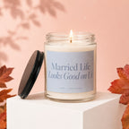Lit candle in glass jar with "Married Life Looks Good on Us" text.