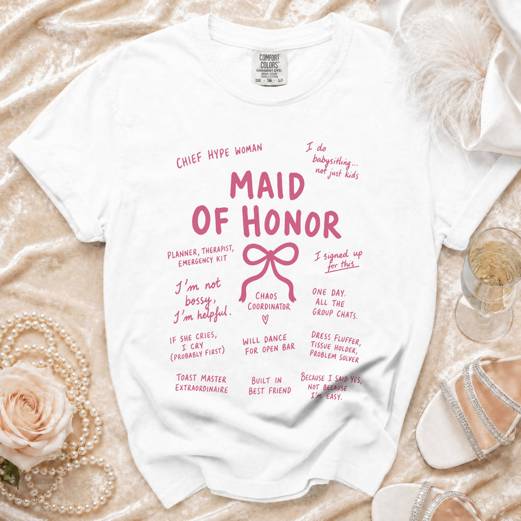 White t-shirt with "Maid of Honor" in pink and various humorous phrases about the role.