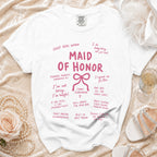 White t-shirt with "Maid of Honor" in pink and various humorous phrases about the role.