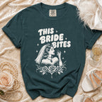 Teal t-shirt with "THIS BRIDE BITES" text and gothic bride graphic.