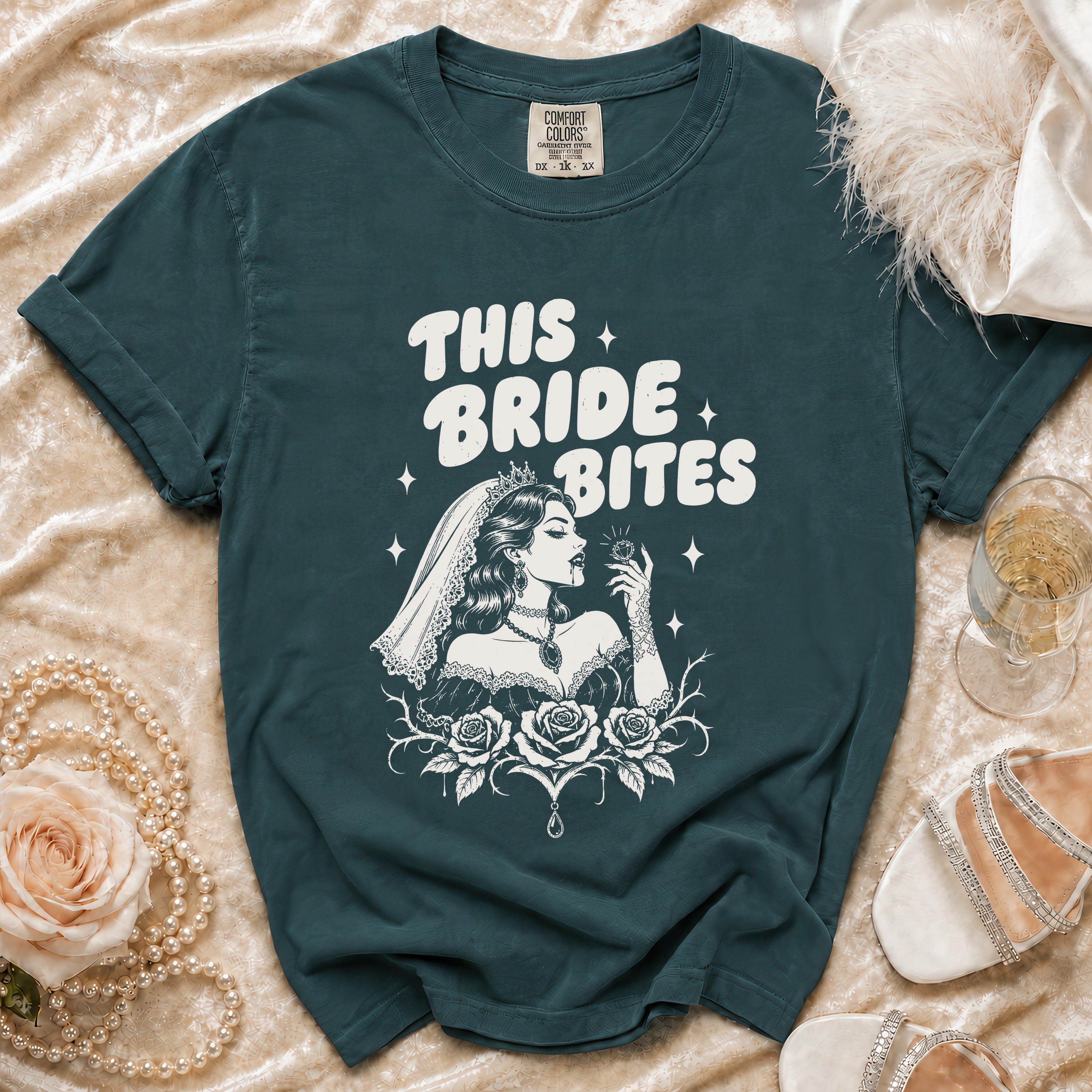 Teal t-shirt with "THIS BRIDE BITES" text and gothic bride graphic.