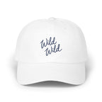 A white baseball cap with the blue embroidered text Wild Wild centered on the front panel.