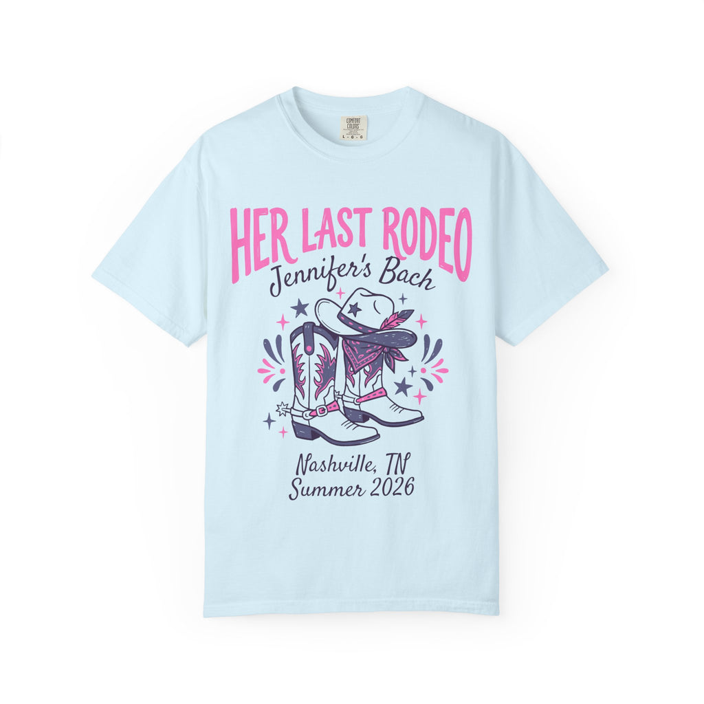 Light blue t-shirt with "Her Last Rodeo" text, cowboy boots, and hat.