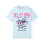 Light blue t-shirt with "Her Last Rodeo" text, cowboy boots, and hat.