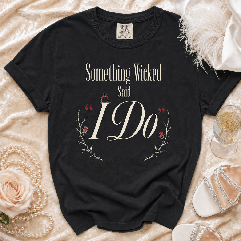 Black Comfort Colors shirt with "Something Wicked Said I Do" text and floral accents.