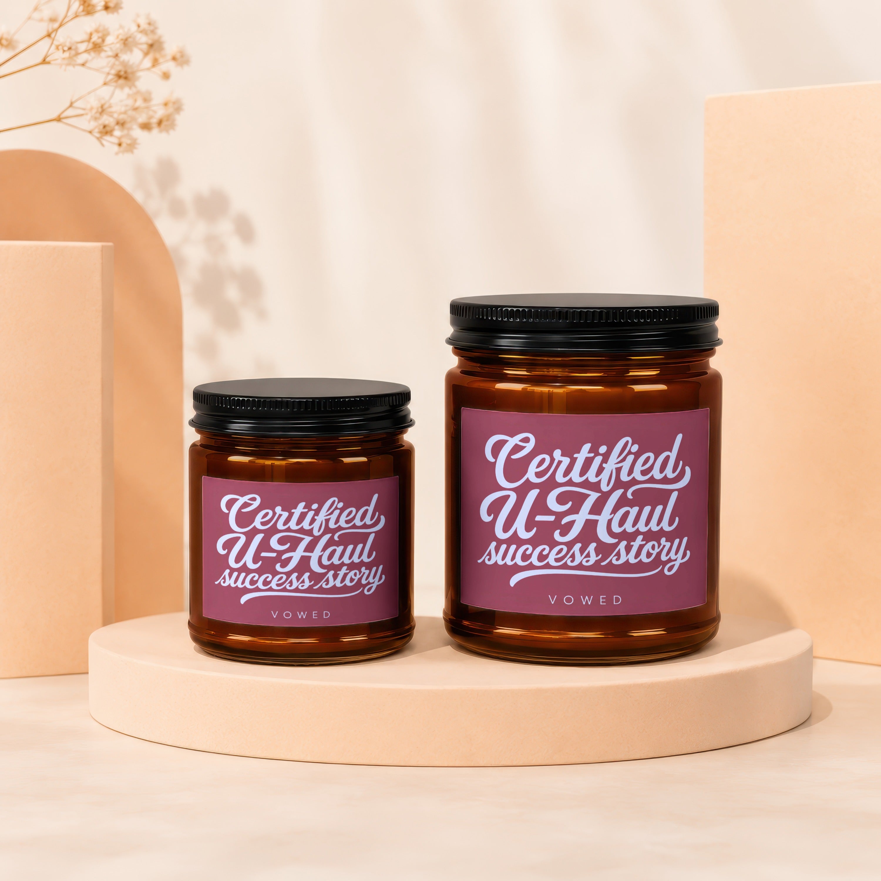 Two brown glass jars with black lids, labels read "Certified U-Haul success story."
