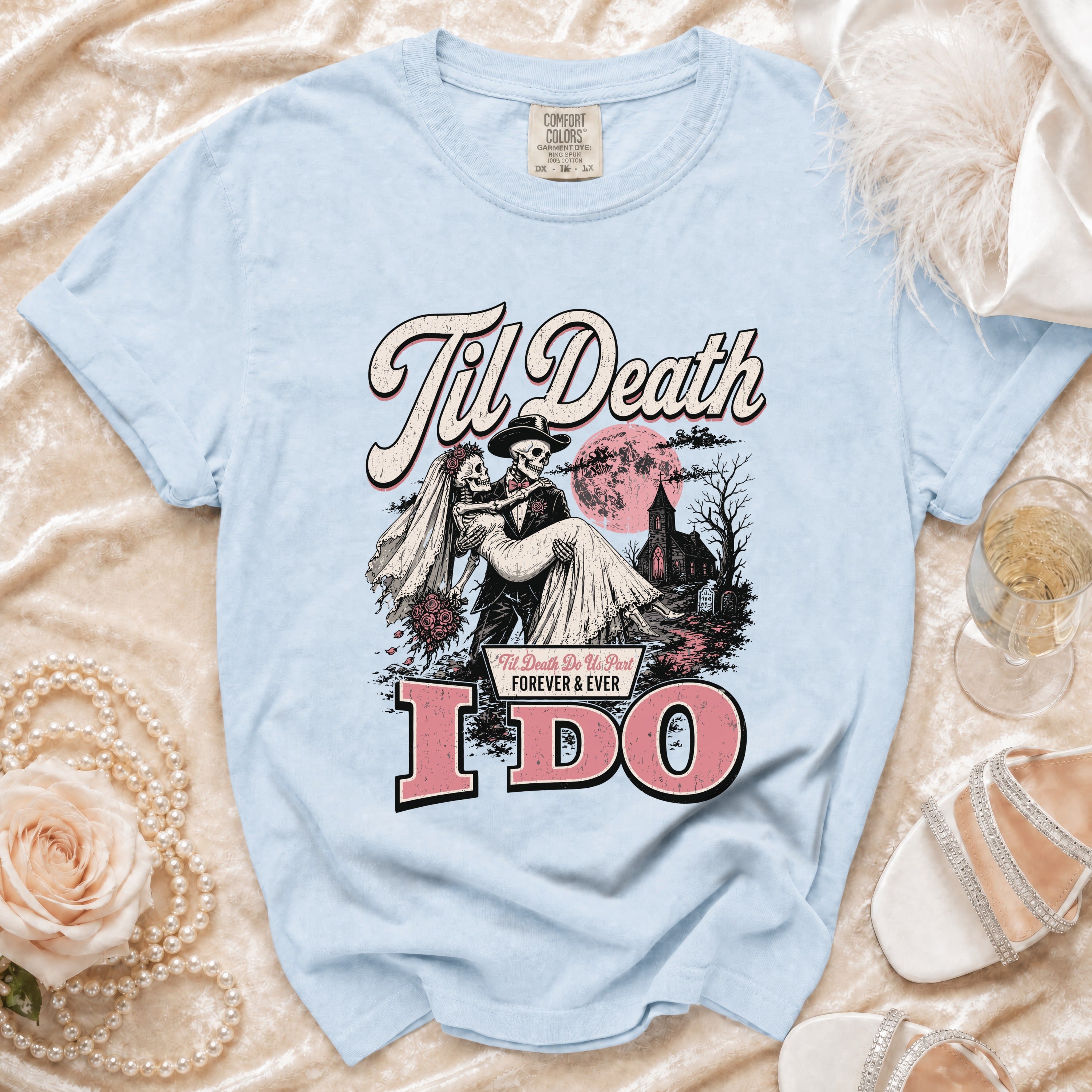 Light blue t-shirt with "Til Death" and skeleton bride and groom graphic saying "I DO".
