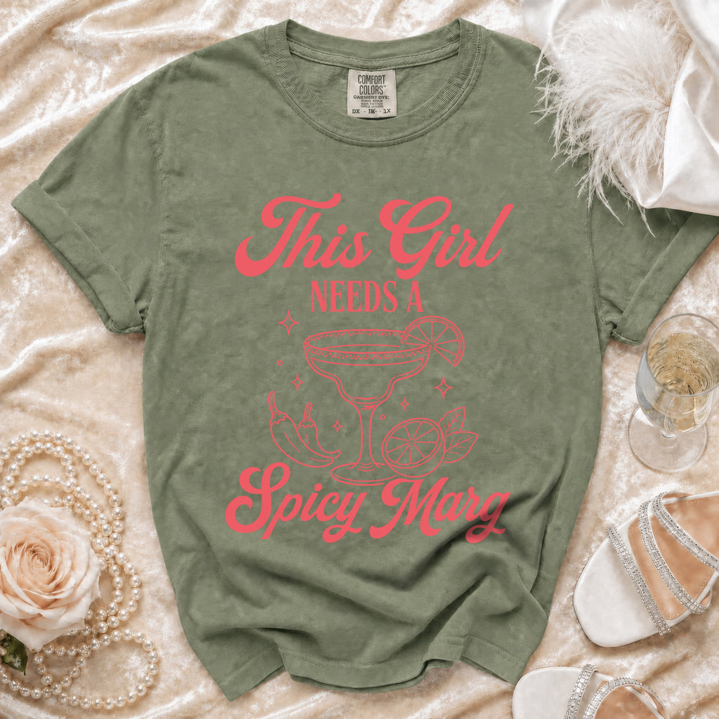 Green t-shirt with hot pink text "This Girl Needs A Spicy M".