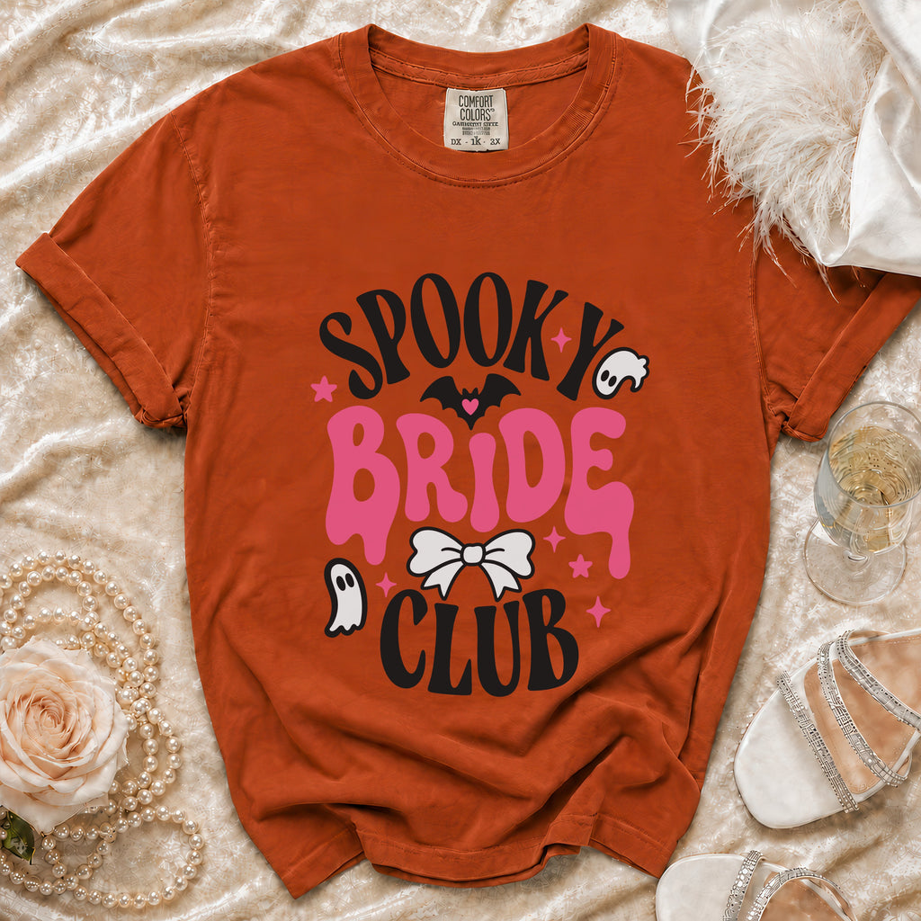 Orange Comfort Colors t-shirt with "Spooky Bride Club" graphic and festive Halloween elements.