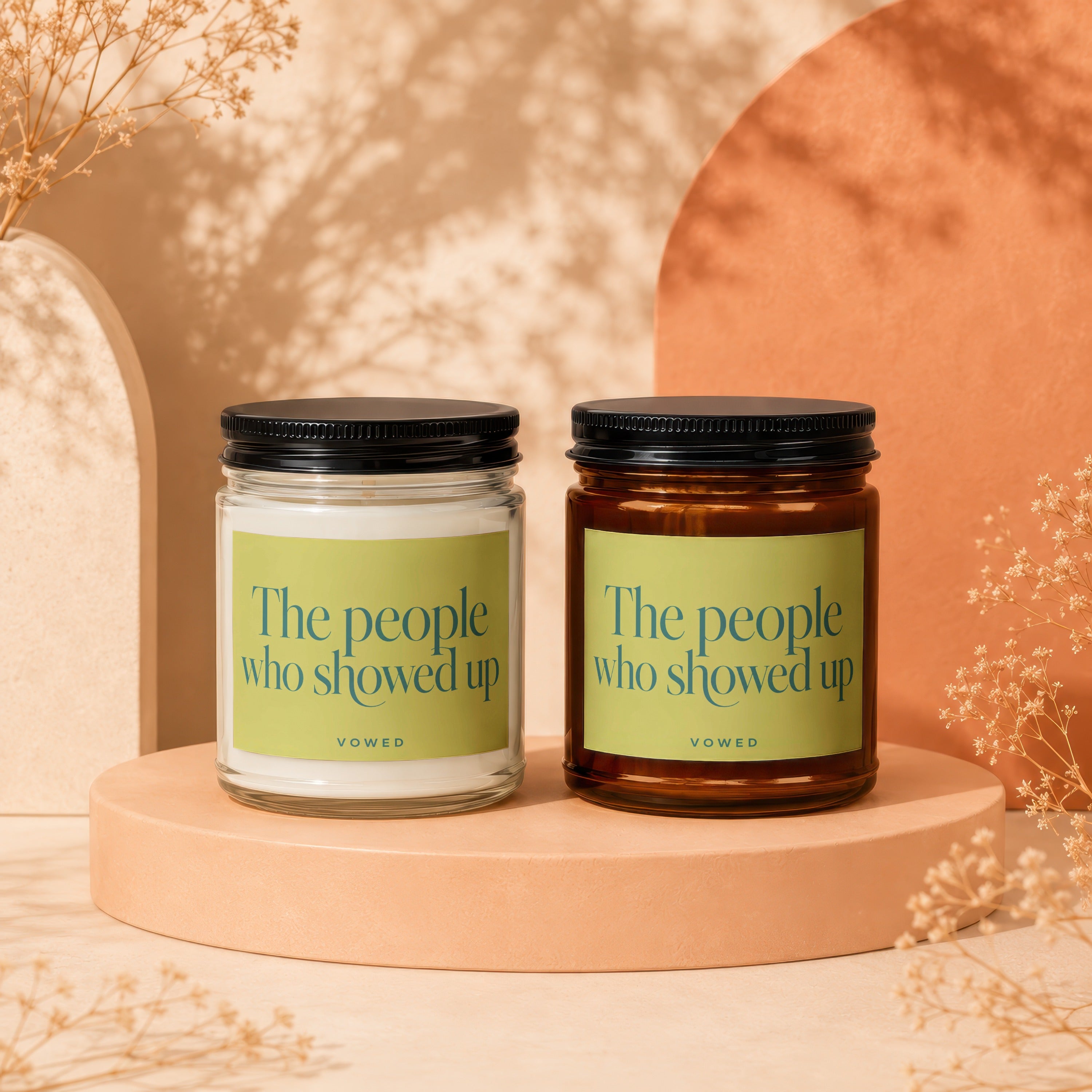 Two candles with labels reading "The people who showed up" by Vowed.