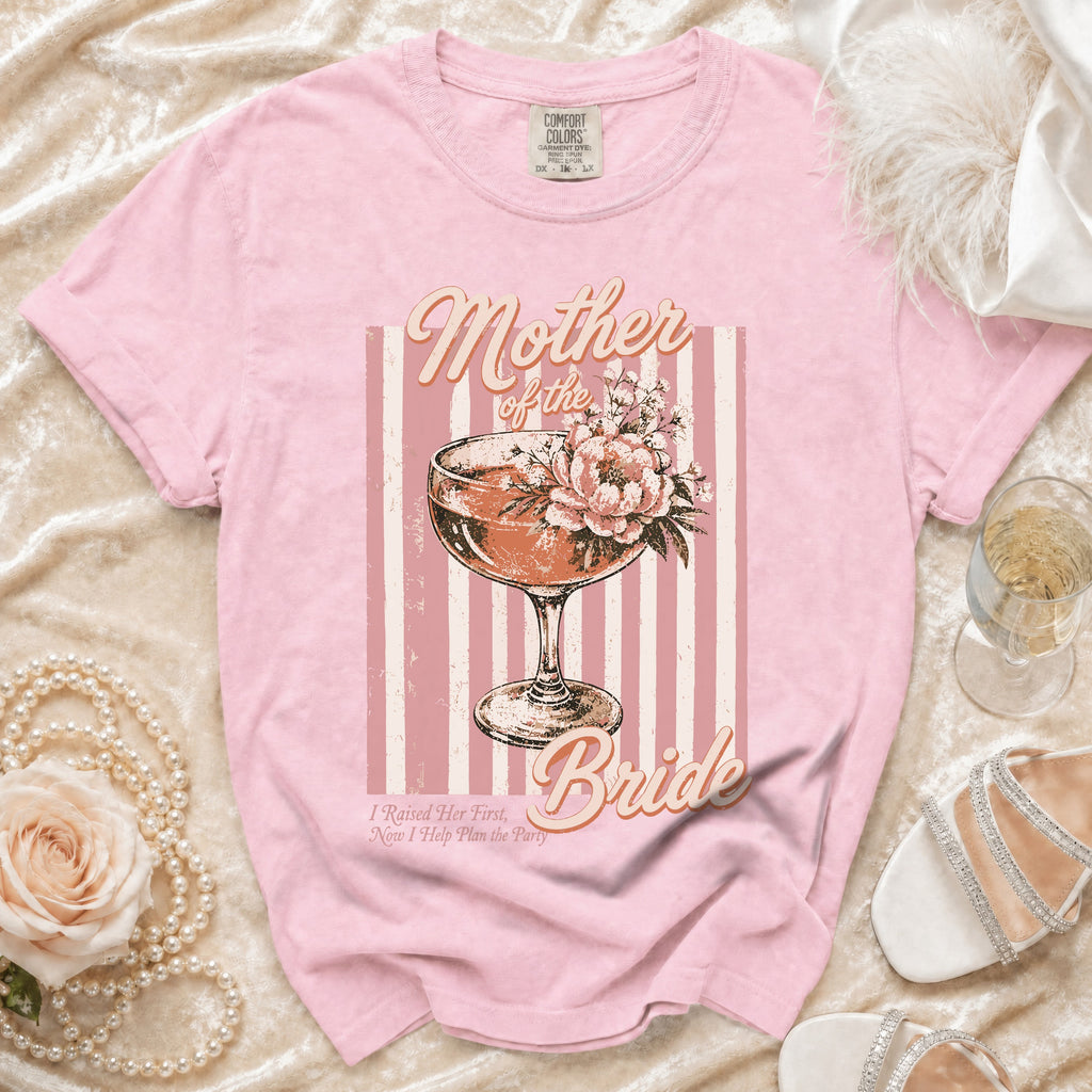 Pink t-shirt with "Mother of the Bride" text, cocktail glass, and flowers graphic.