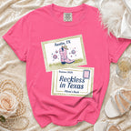 Pink t-shirt with "Austin, TX" and "Reckless in Texas Olivia's Bach" designs.